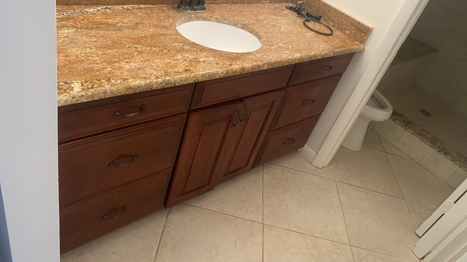 Dark bathroom vanity before cabinet refresh