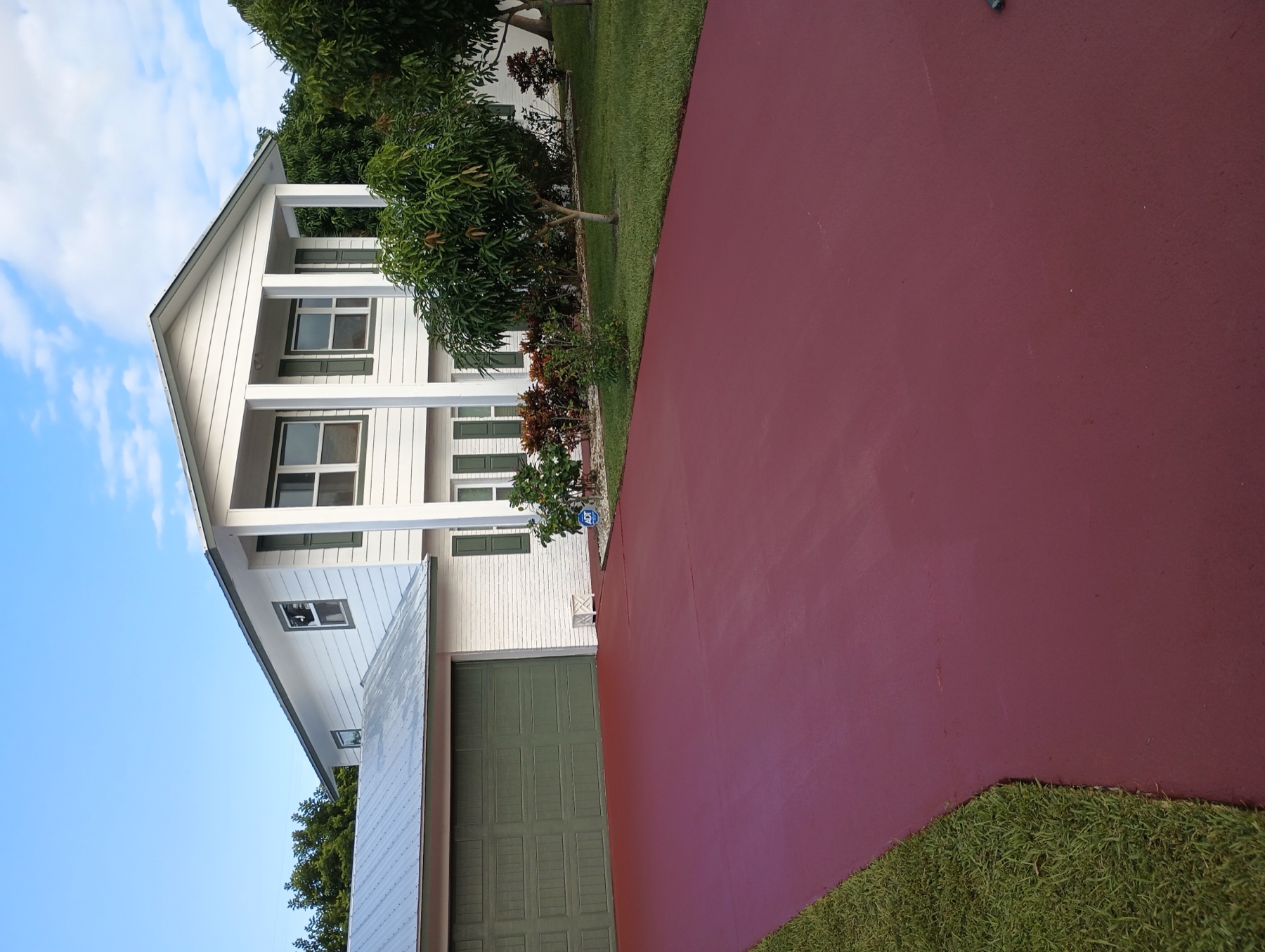 Same driveway freshly coated in a deep red finish